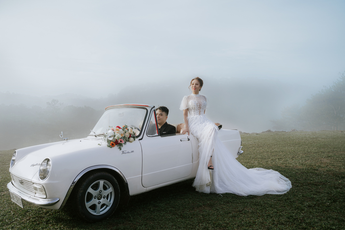 Couple in Wedding Dress Standing on Green Grass Field